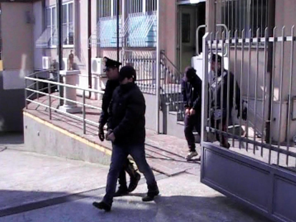 Due dei giovani arrestati escono dalla caserma.FOTOLIVE   